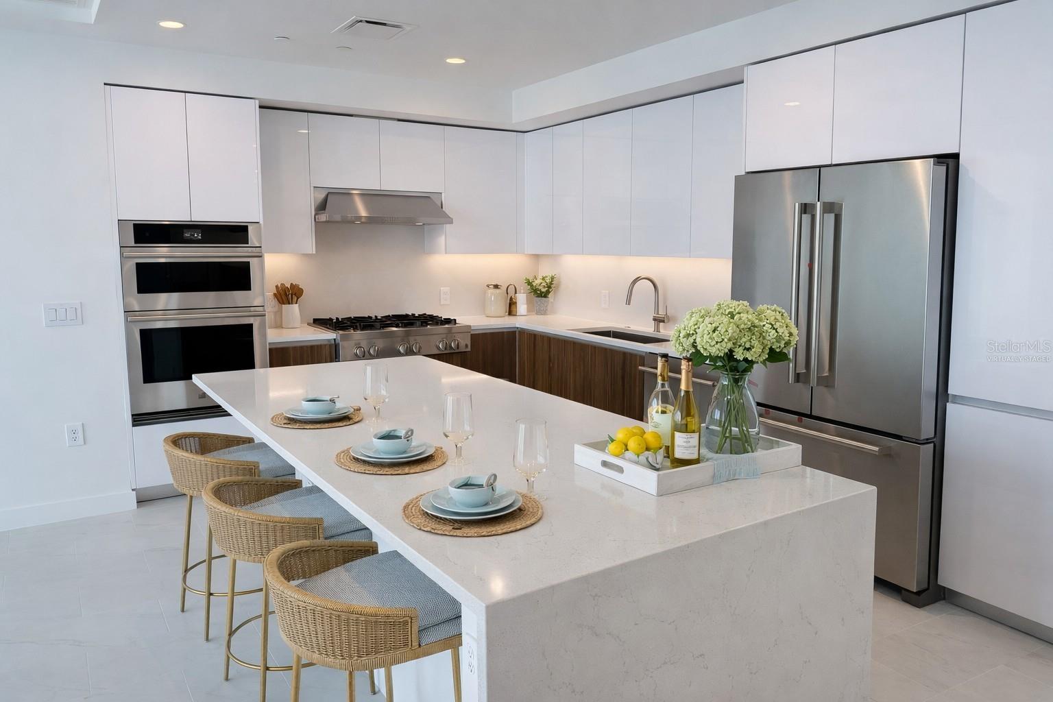 Waterfall Quartz Island  / Breakfast Bar / Kitchen with Stainless Steel Jenn Air Appliances - Virtually Staged