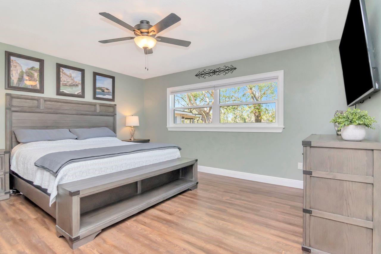 Primary Bedroom with Window looking out to Backyard & Water View