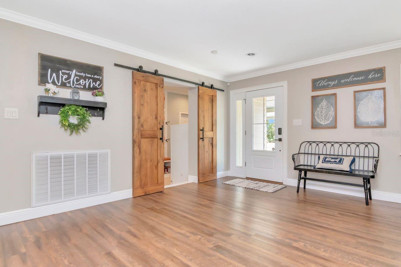 Entryway and Barn Doors Leading to Mud Room & Inside Laundry