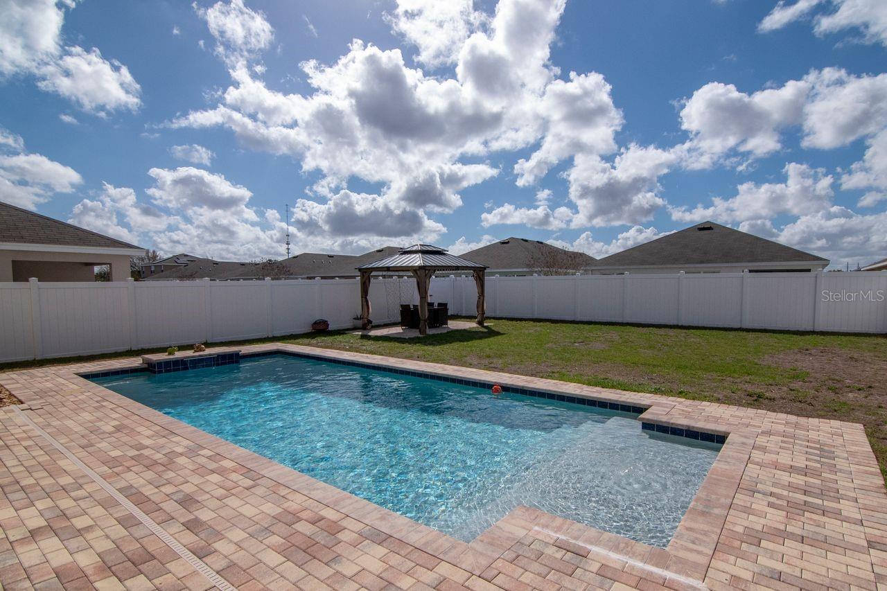Beautiful pool with lighting and fountain features - pavered lanai and custom gazebo