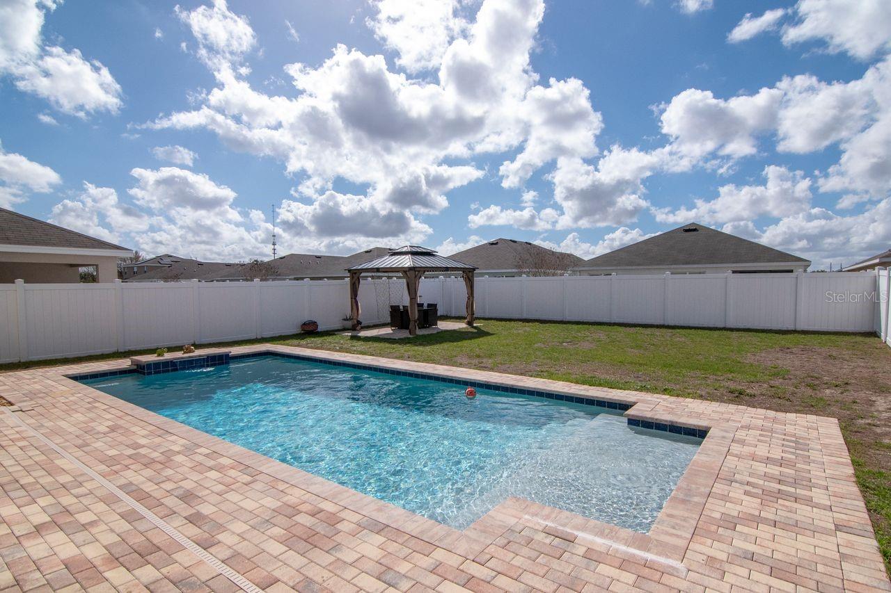 Beautiful pool with lighting and fountain features - pavered lanai and custom gazebo