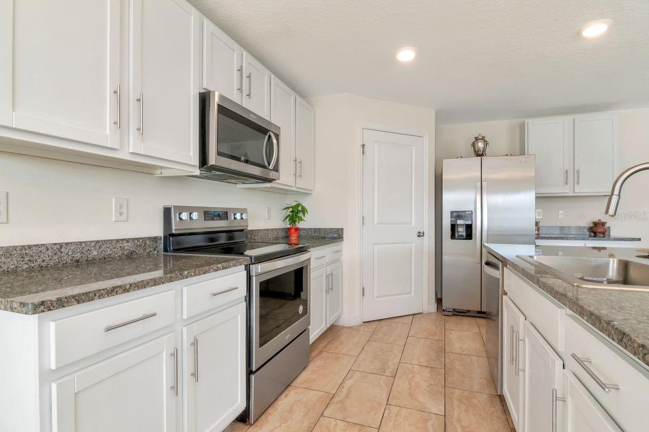 Kitchen with white cabinets, granite countertops