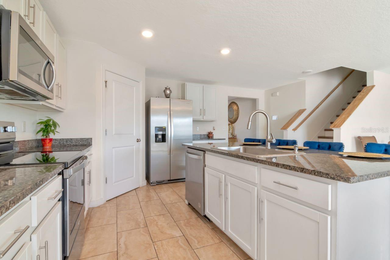 Kitchen with white cabinets, granite countertops