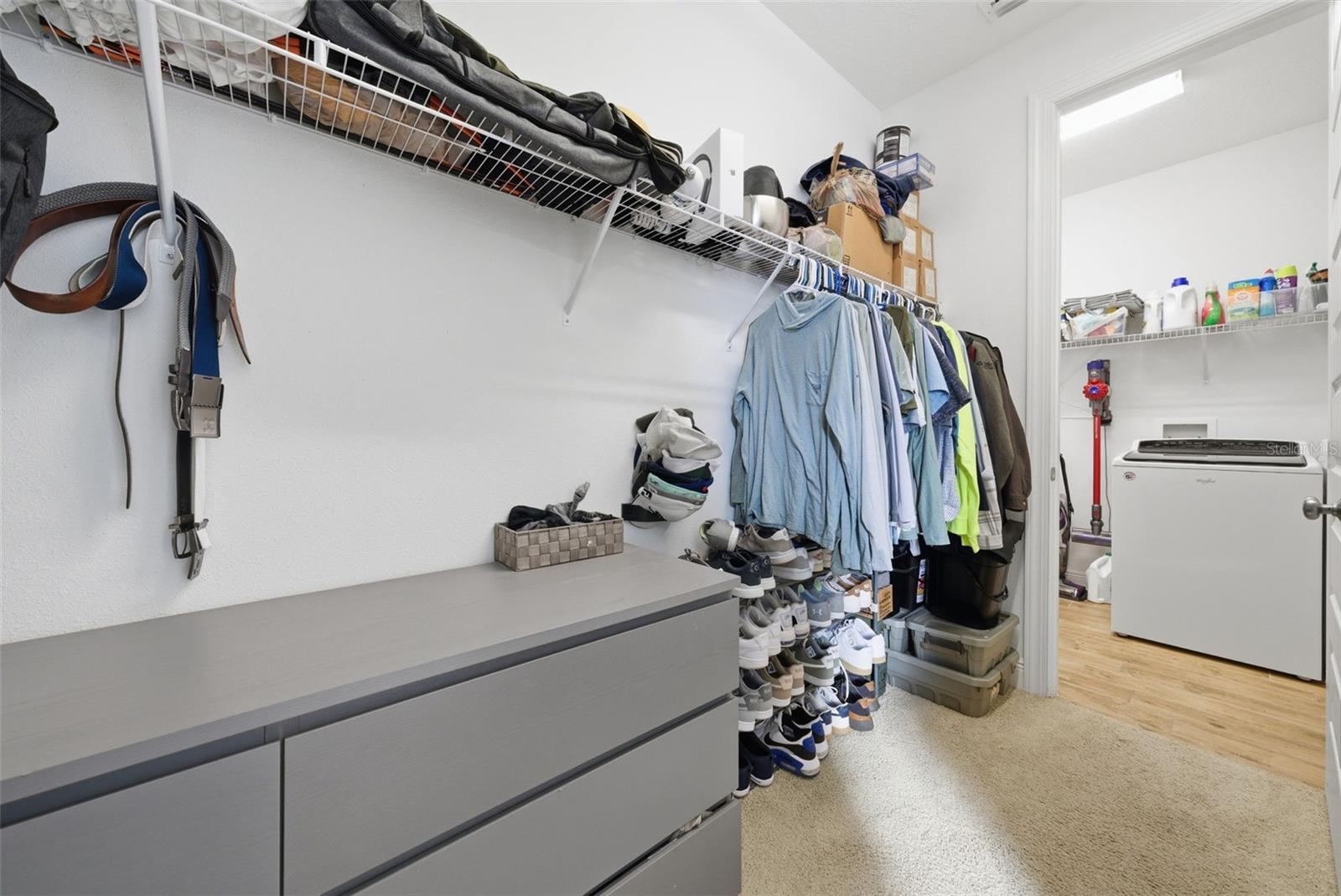 Primary Walk In Closet, connects to laundry room