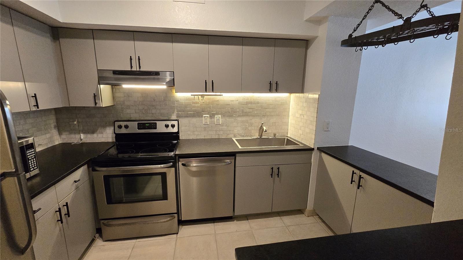 Kitchen area with SS appliances