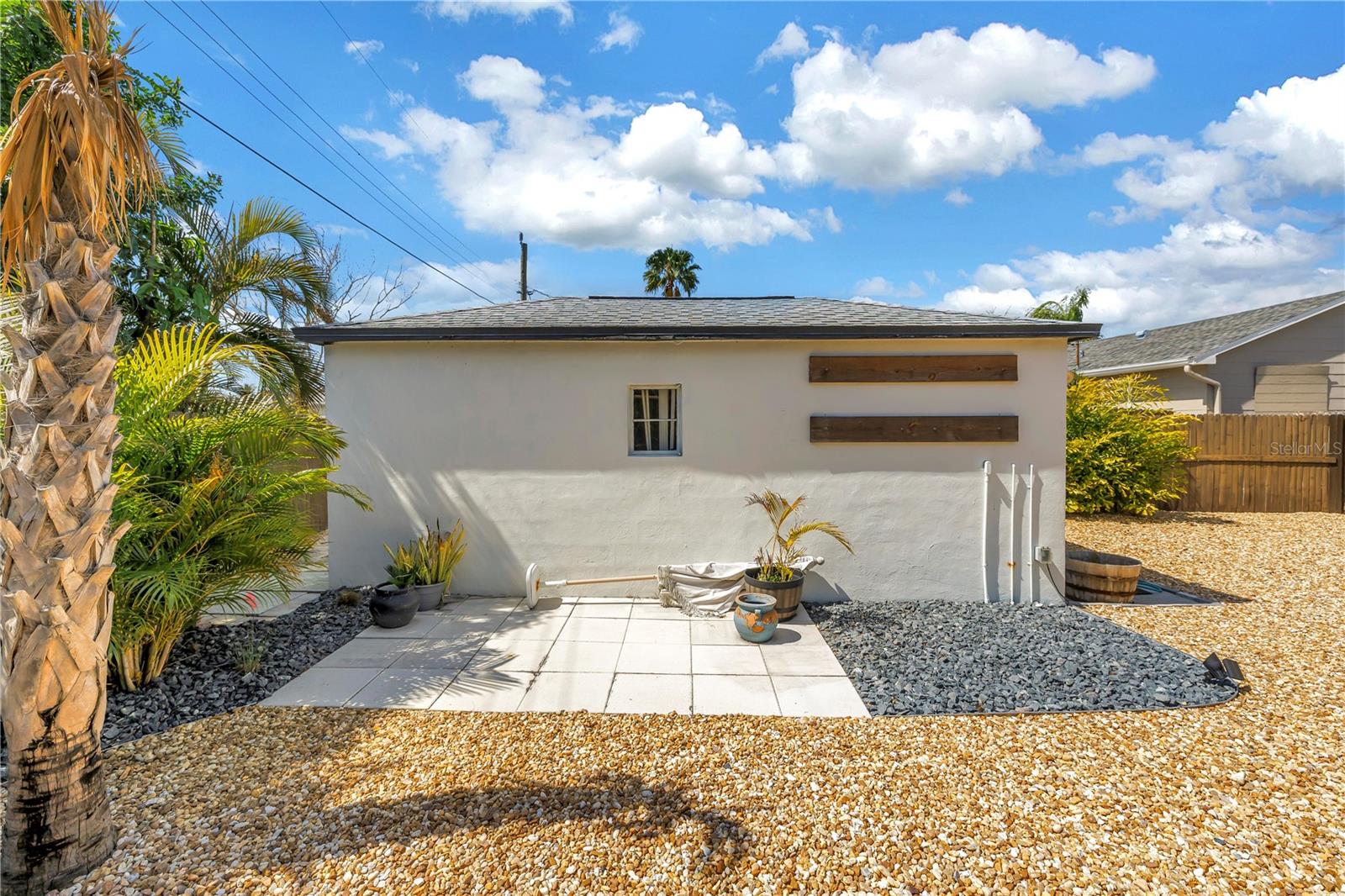 Paved patio next to garage
