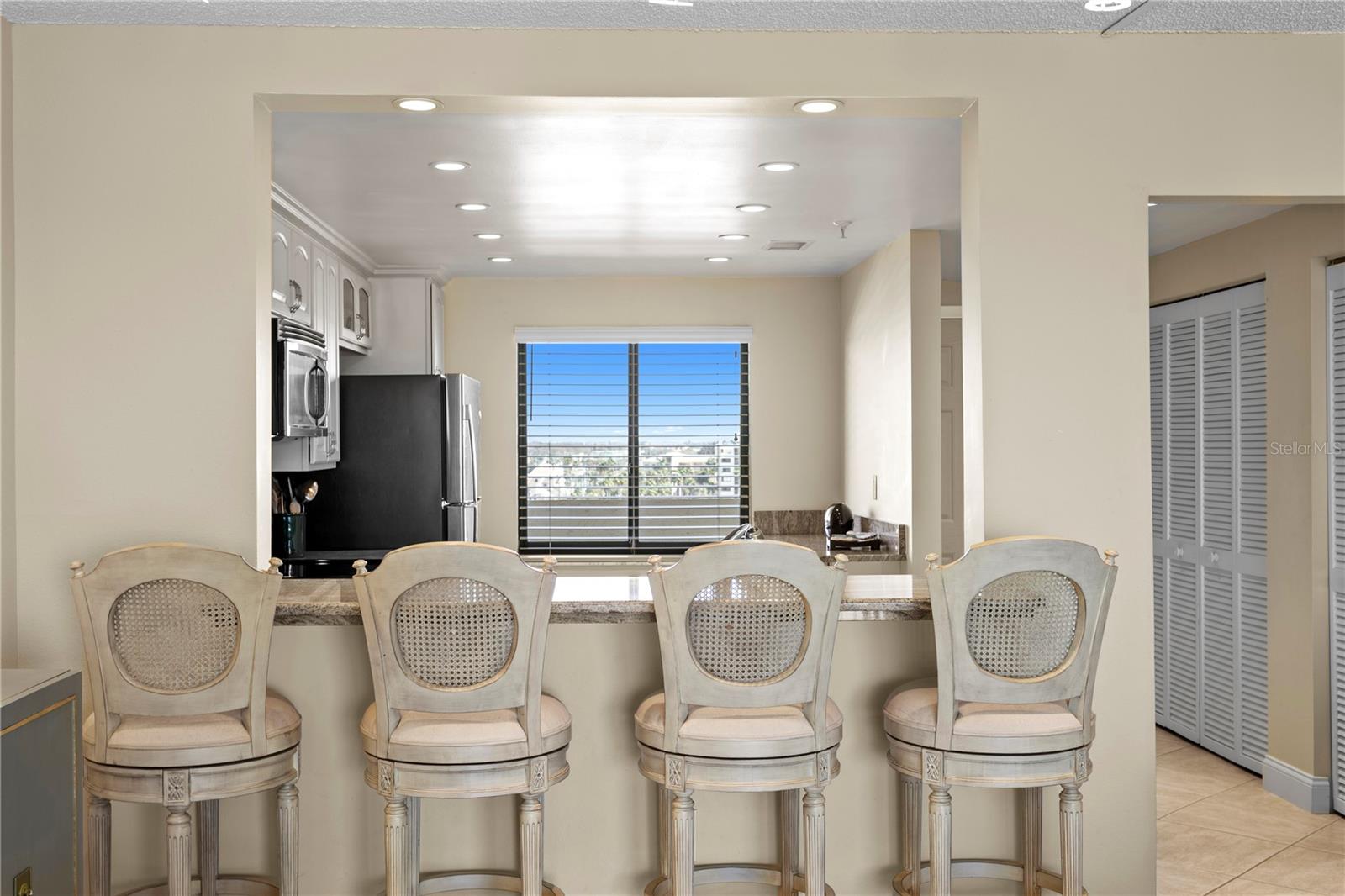 The kitchen has bar seating — perfect for gathering after a day in the sun