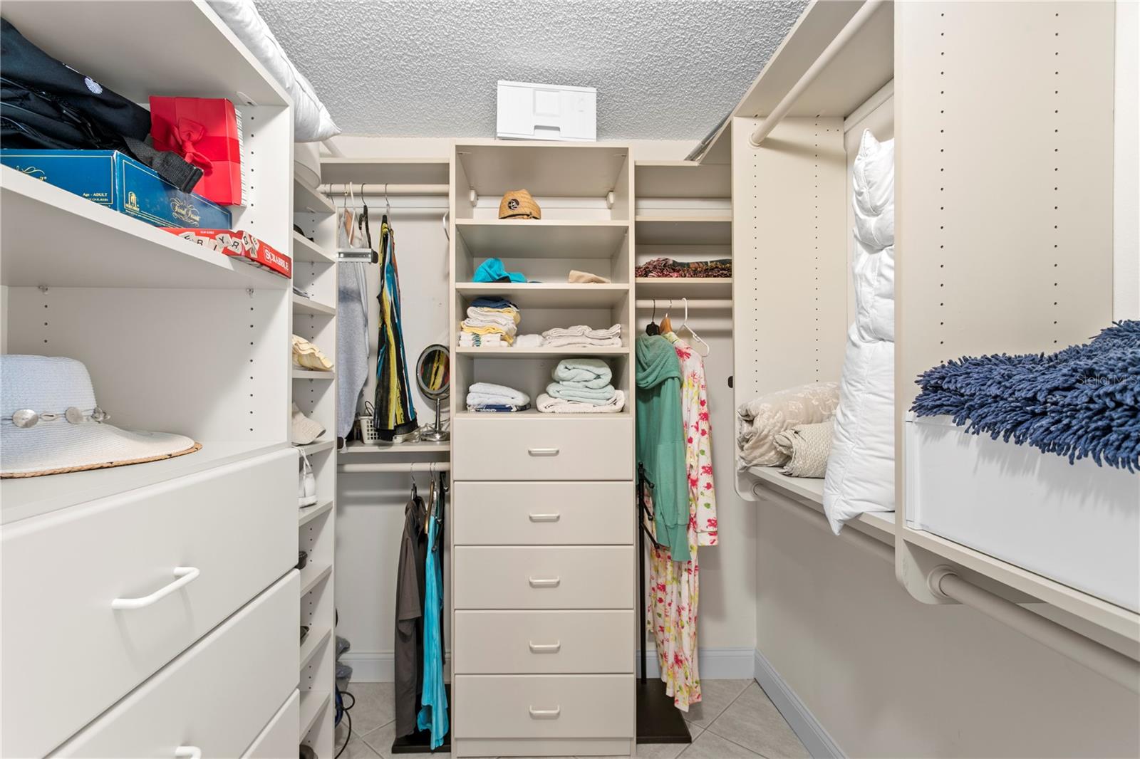 A generous walk-in closet with closet organizers
