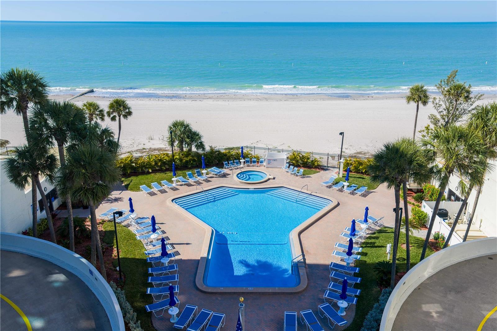 Residents enjoy direct beach access along with resort-style amenities including a pool, shuffleboard, fire pit, and tiki hut — truly embracing the “no shoes, no shirt, no problem” lifestyle.