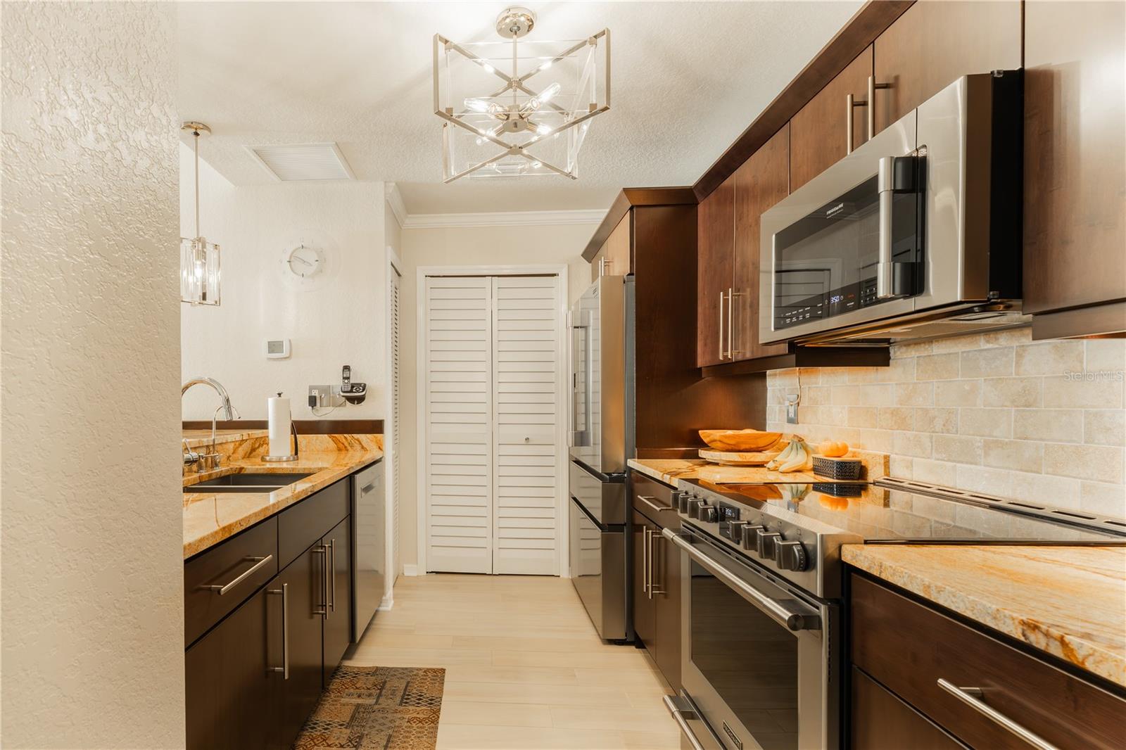 With sleek stainless steel appliances, gorgeous granite countertops, and stylish lighting, this space is truly a chef’s dream.