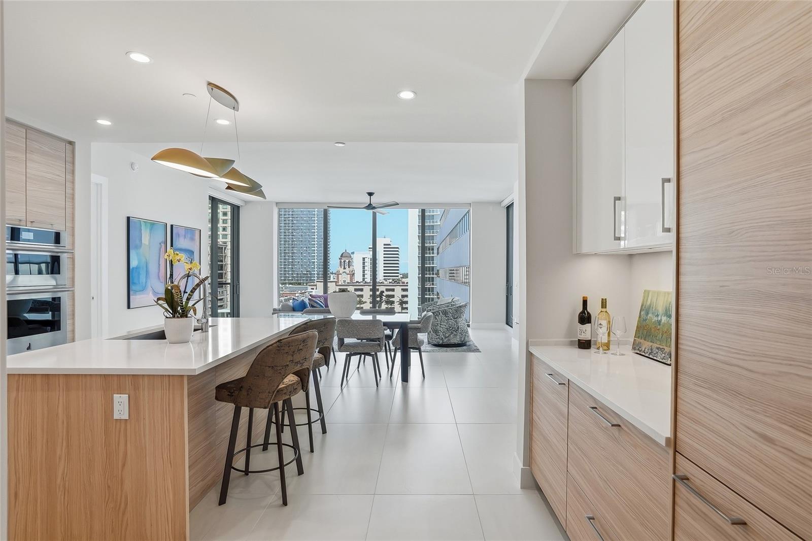 Residence 1104 at Saltaire offers over 2,000 sq ft with 2 bedrooms, 3 full baths, a versatile den, two private terraces, two adjacent parking spaces, and stunning Tampa Bay and Downtown St. Petersburg views.