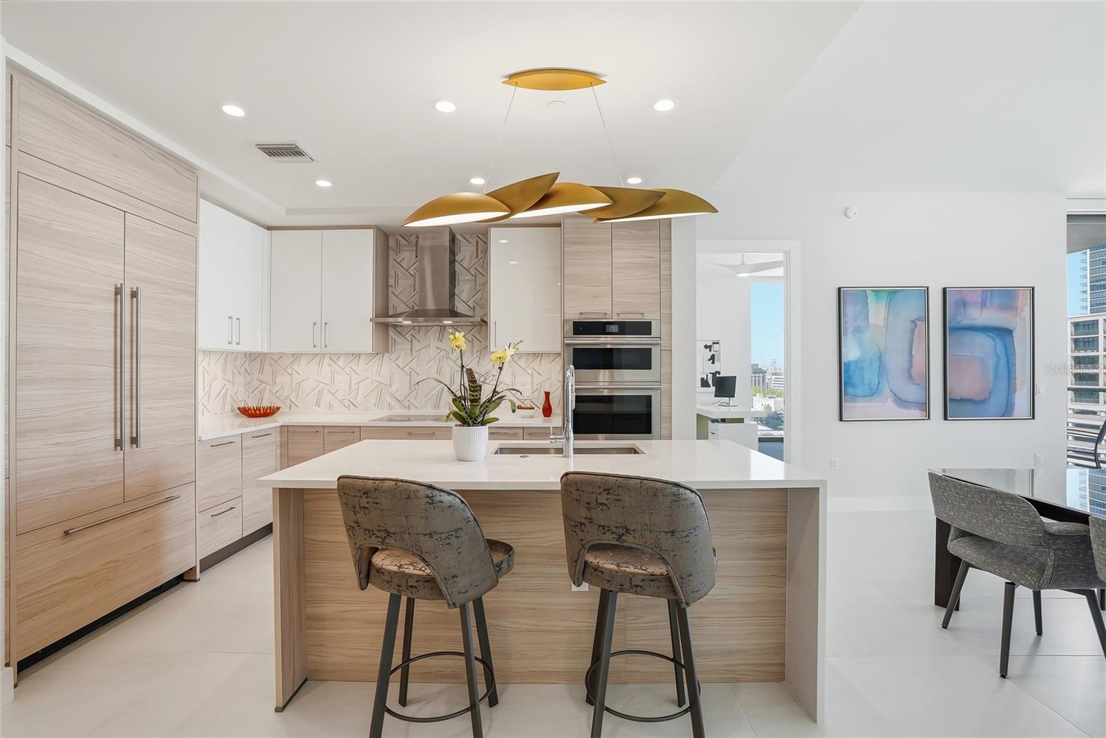 Spacious open kitchen with JennAir appliances, paneled refrigerator, and elegant finishes designed for everyday living and entertaining.