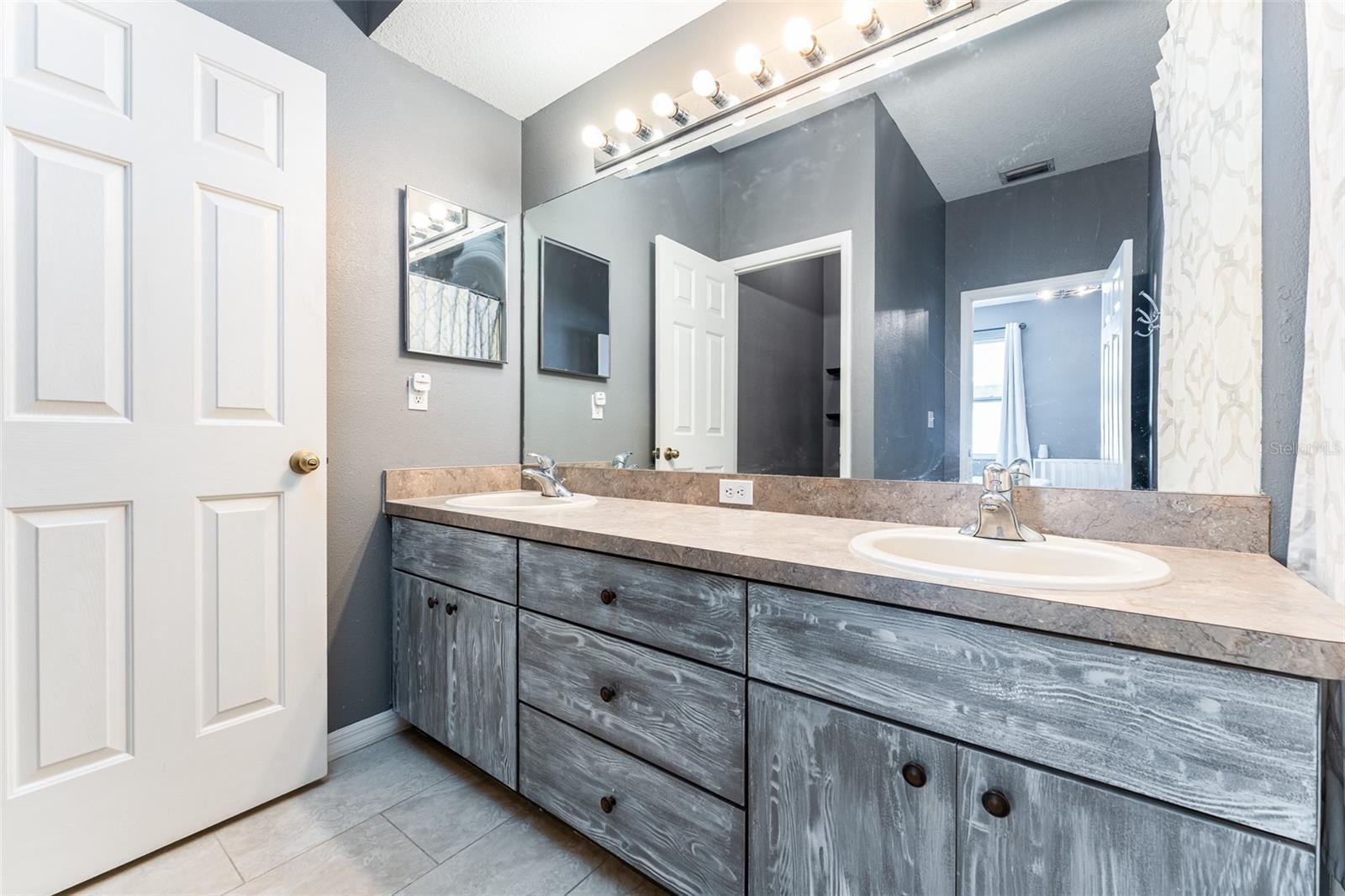 Primary bathroom with dual sinks & garden tub /shower combination