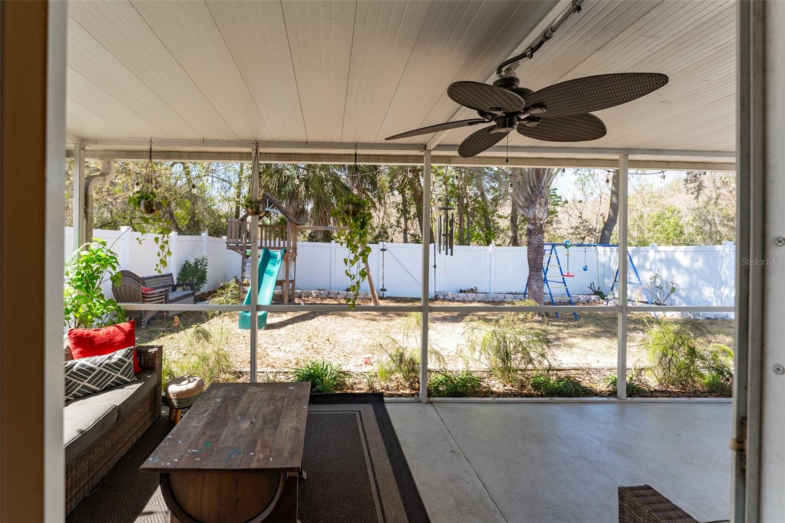 view from kitchen of the large covered & screened lanai
