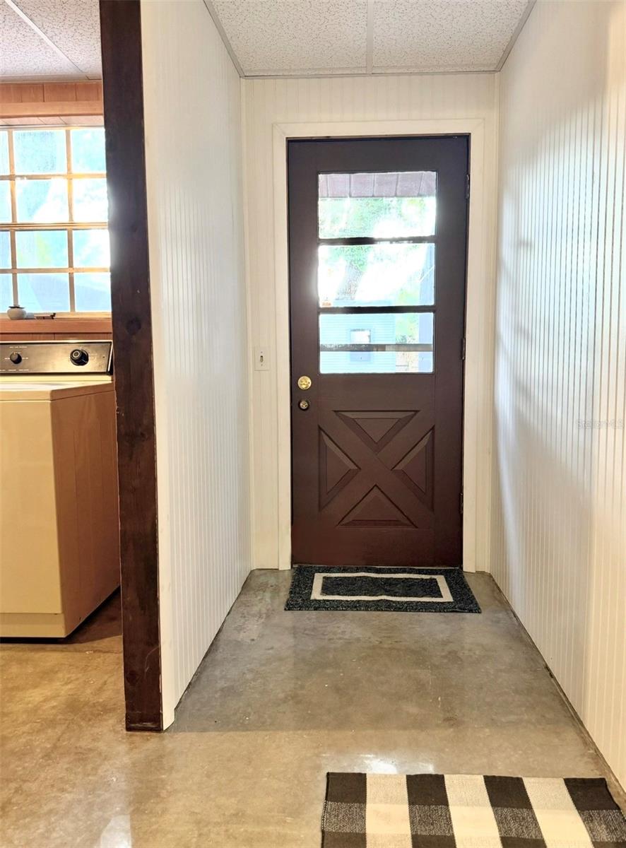 Back entry doorway, adjacent to the kitchen and laundry room.