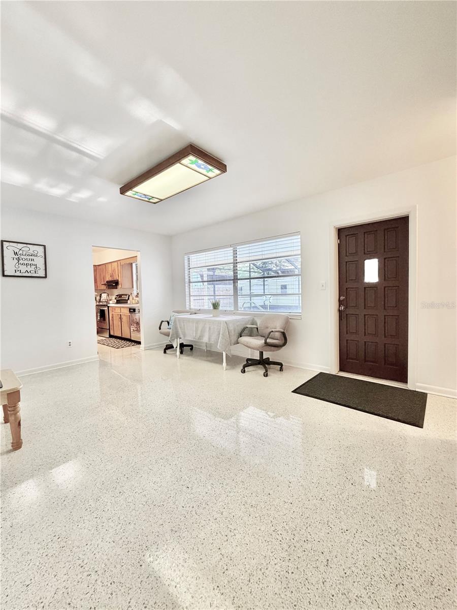 Living Room has built-in shelving and overlooks the pool through a large window.