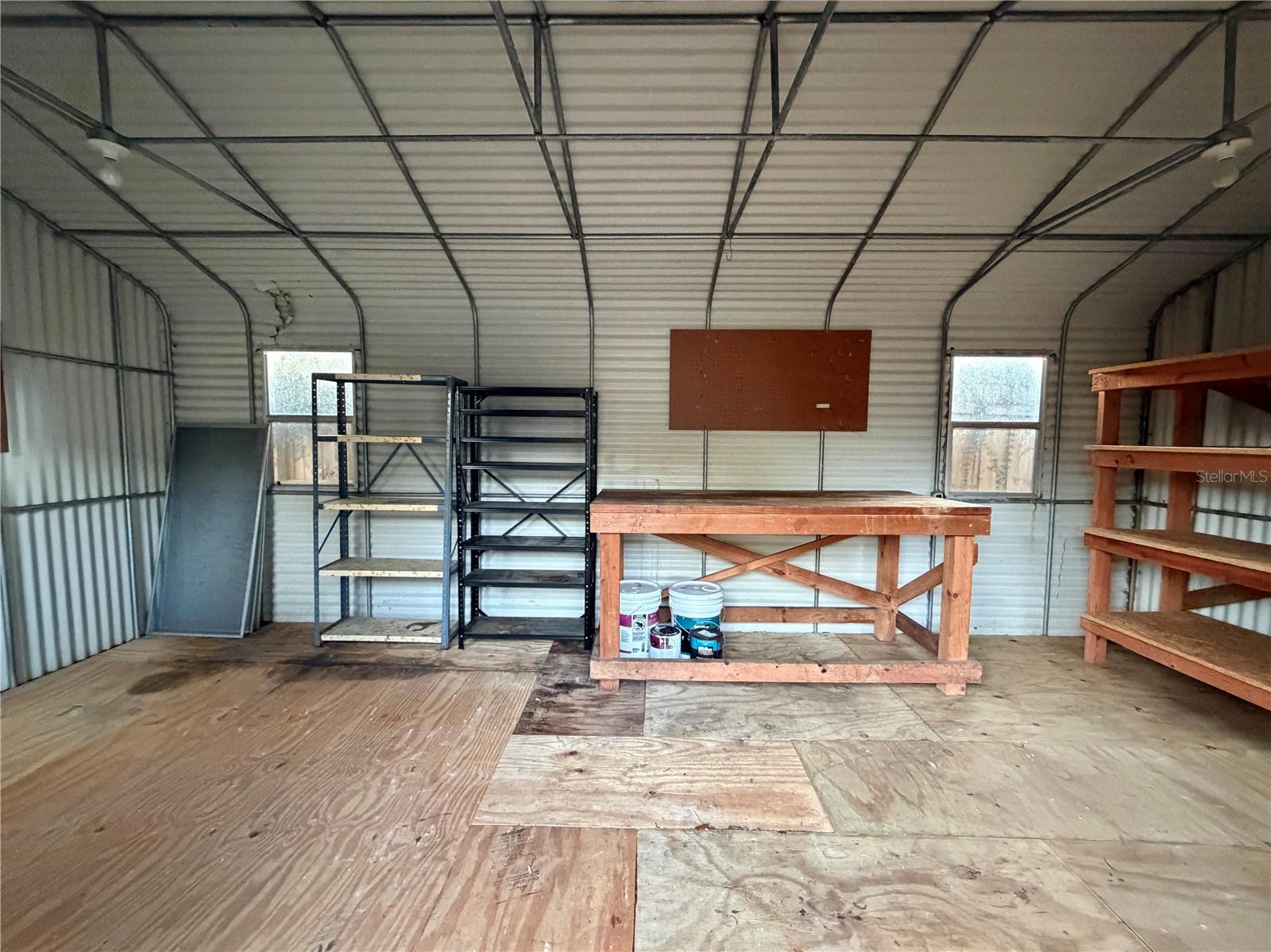 Extra Large Shed has pegboards and shelving.