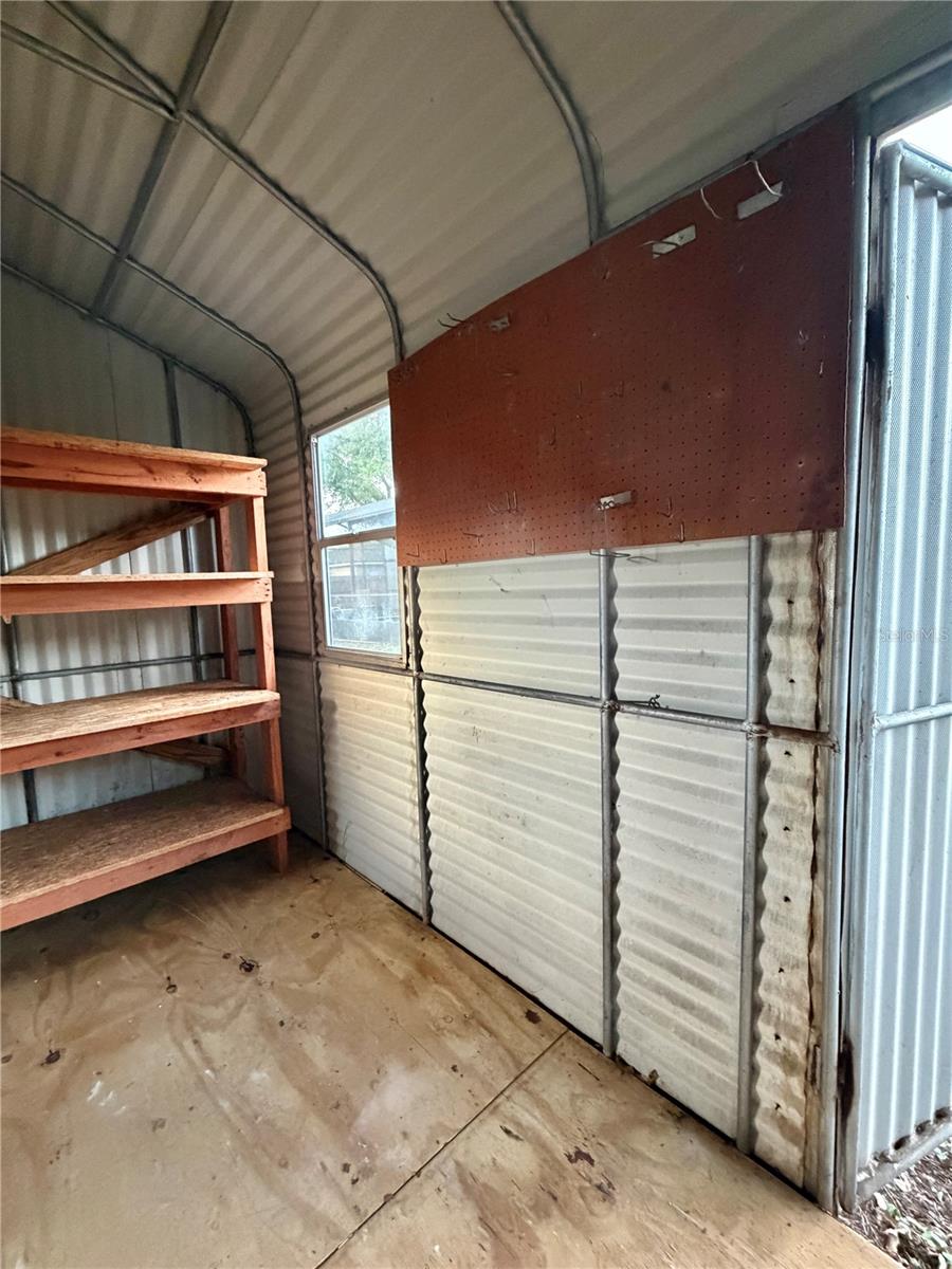 Extra Large Shed has pegboards and shelving.