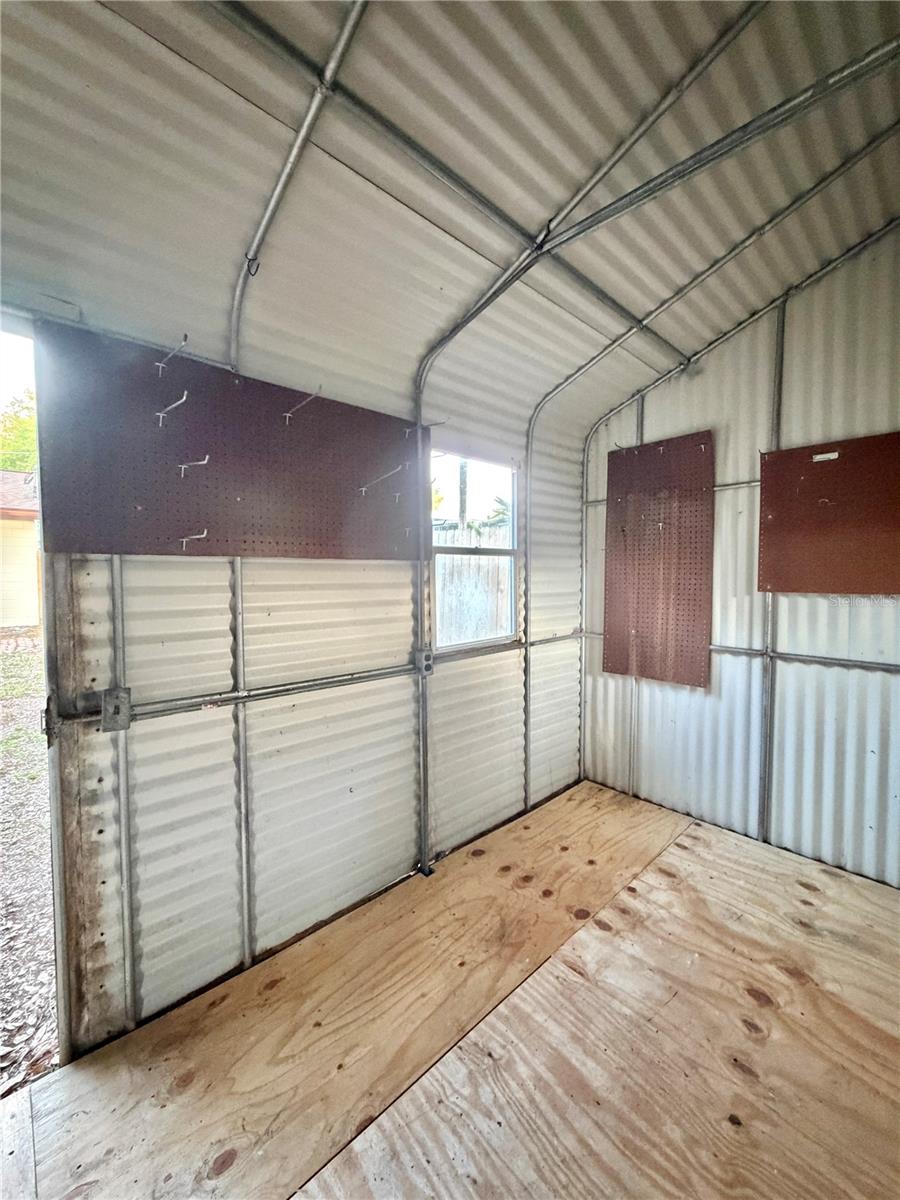 Extra Large Shed has pegboards and shelving.