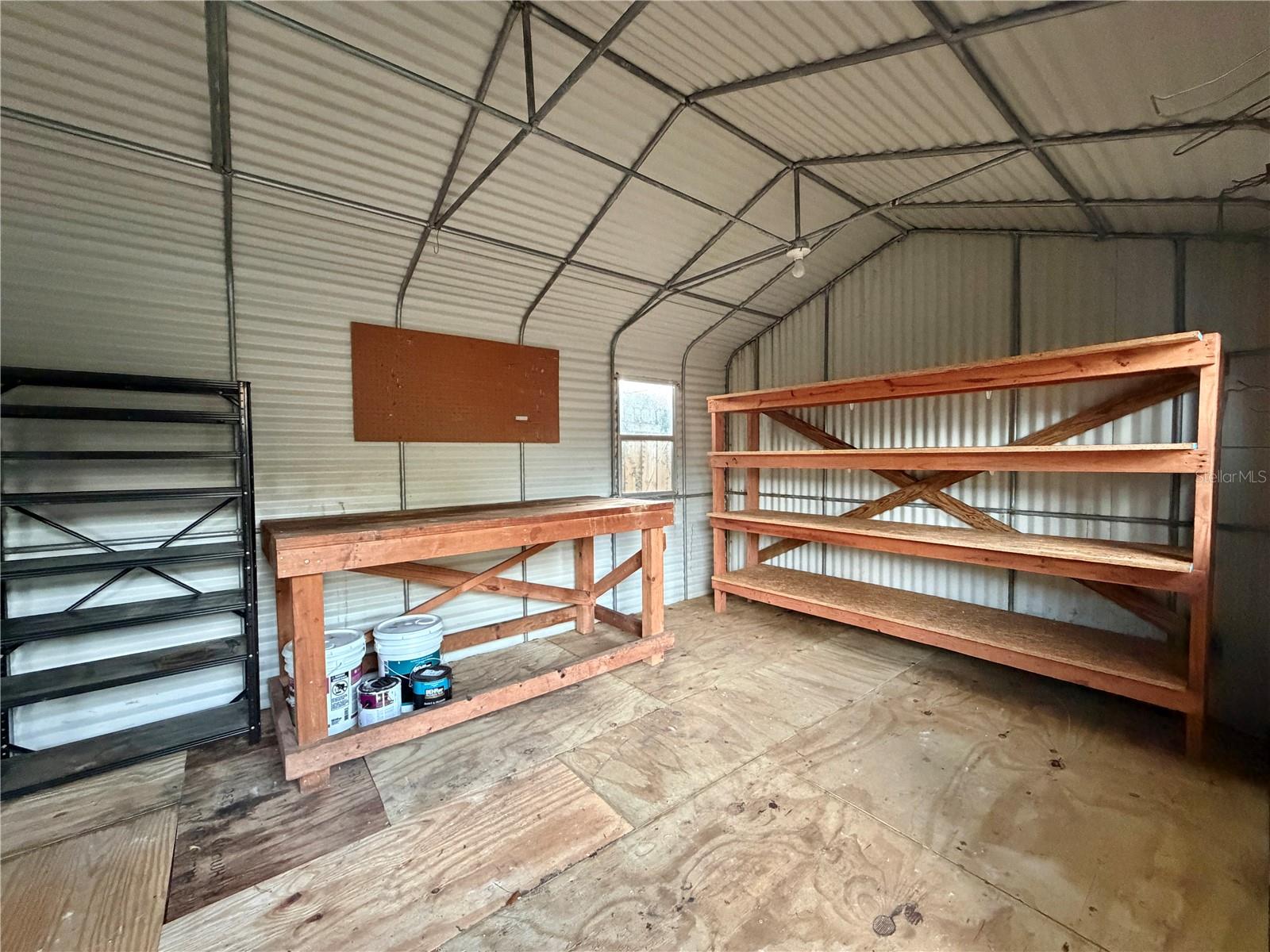 Extra Large Shed has pegboards and shelving.
