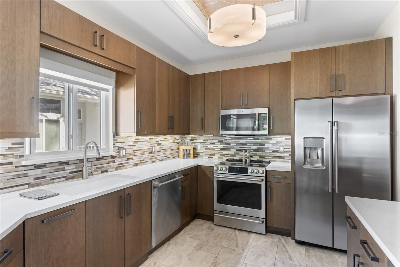 Custom Kitchen with High End Cabinetry, Stainless Steel GE Cafe' Appliances and Quartz Countertops