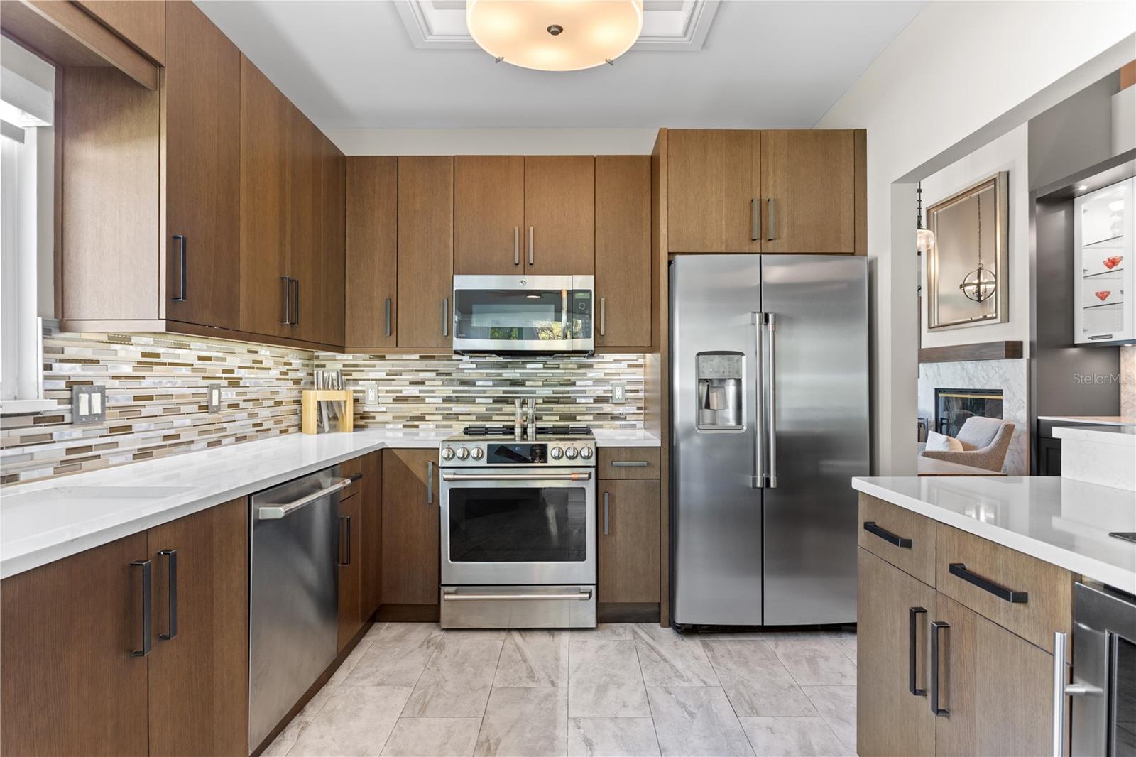 Custom Kitchen with High End Cabinetry, Stainless Steel GE Cafe' Appliances and Quartz Countertops