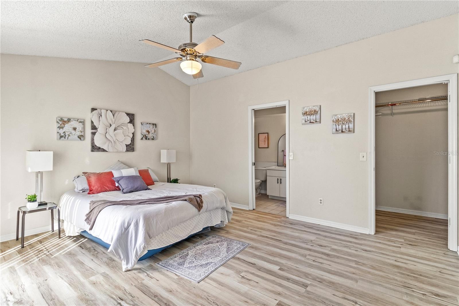 Primary Bedroom with sunny sliding doors and LVP