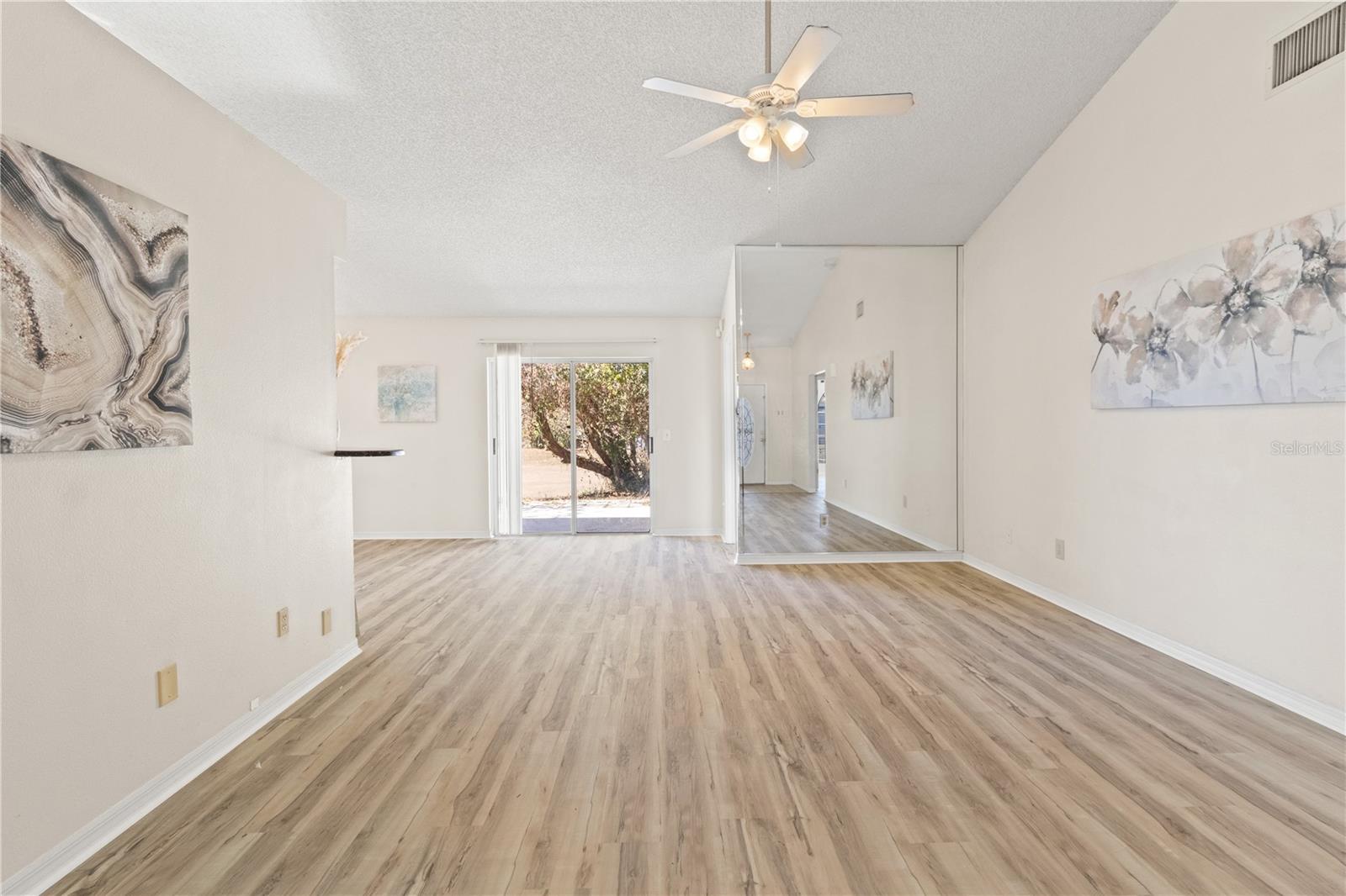 From the entryway.  Living room with new flooring and tall ceilings
