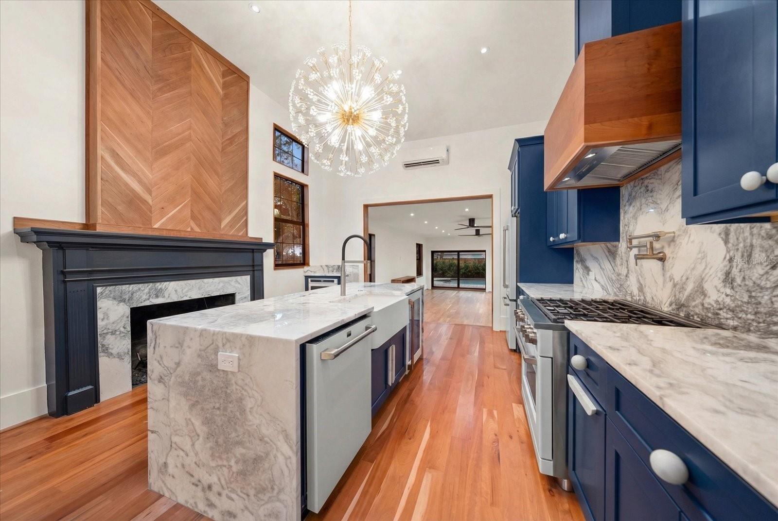 Kitchen with custom hood vent, 6 burner GE Café range