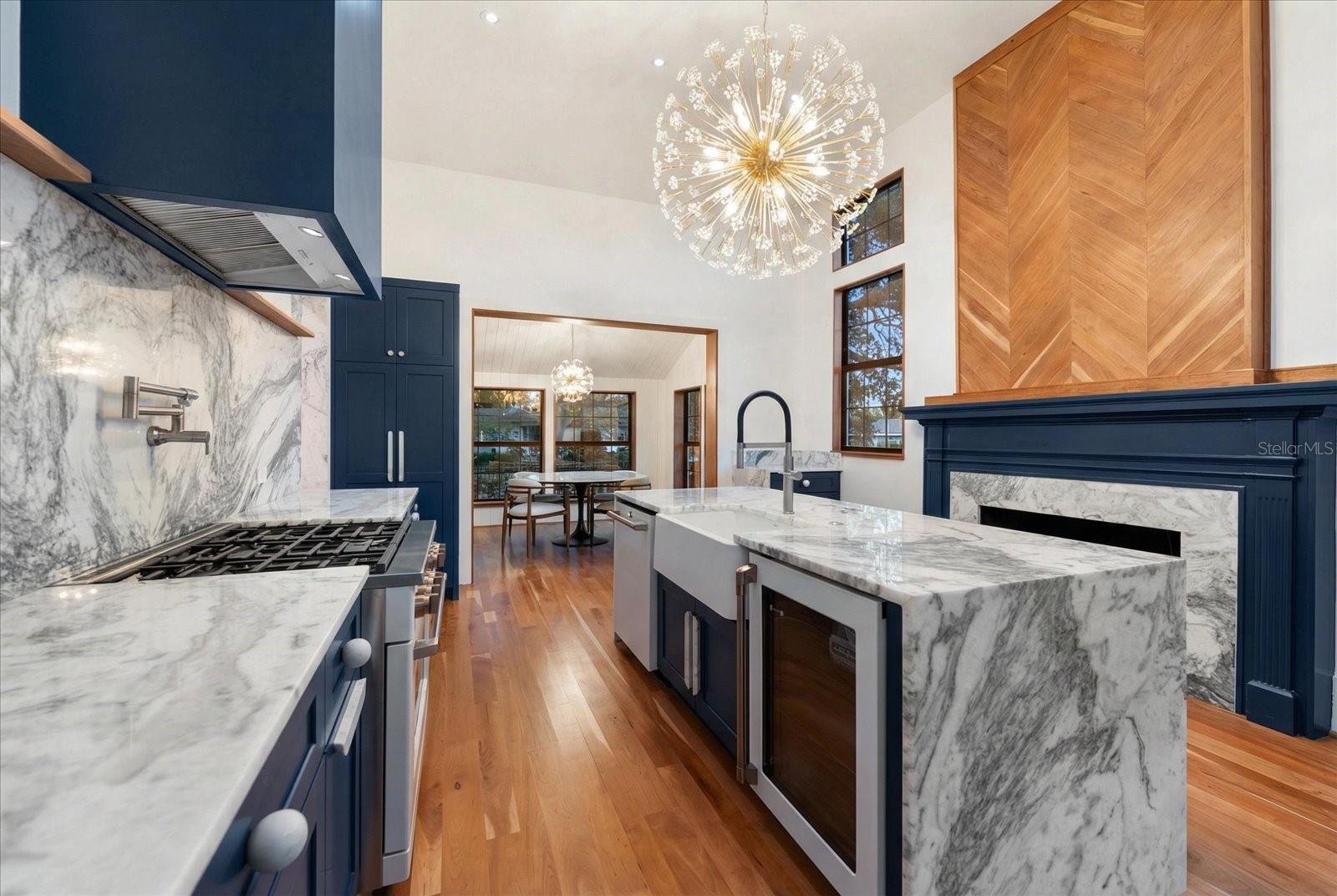 Kitchen with farmhouse apron front sink, and wine refrigerator