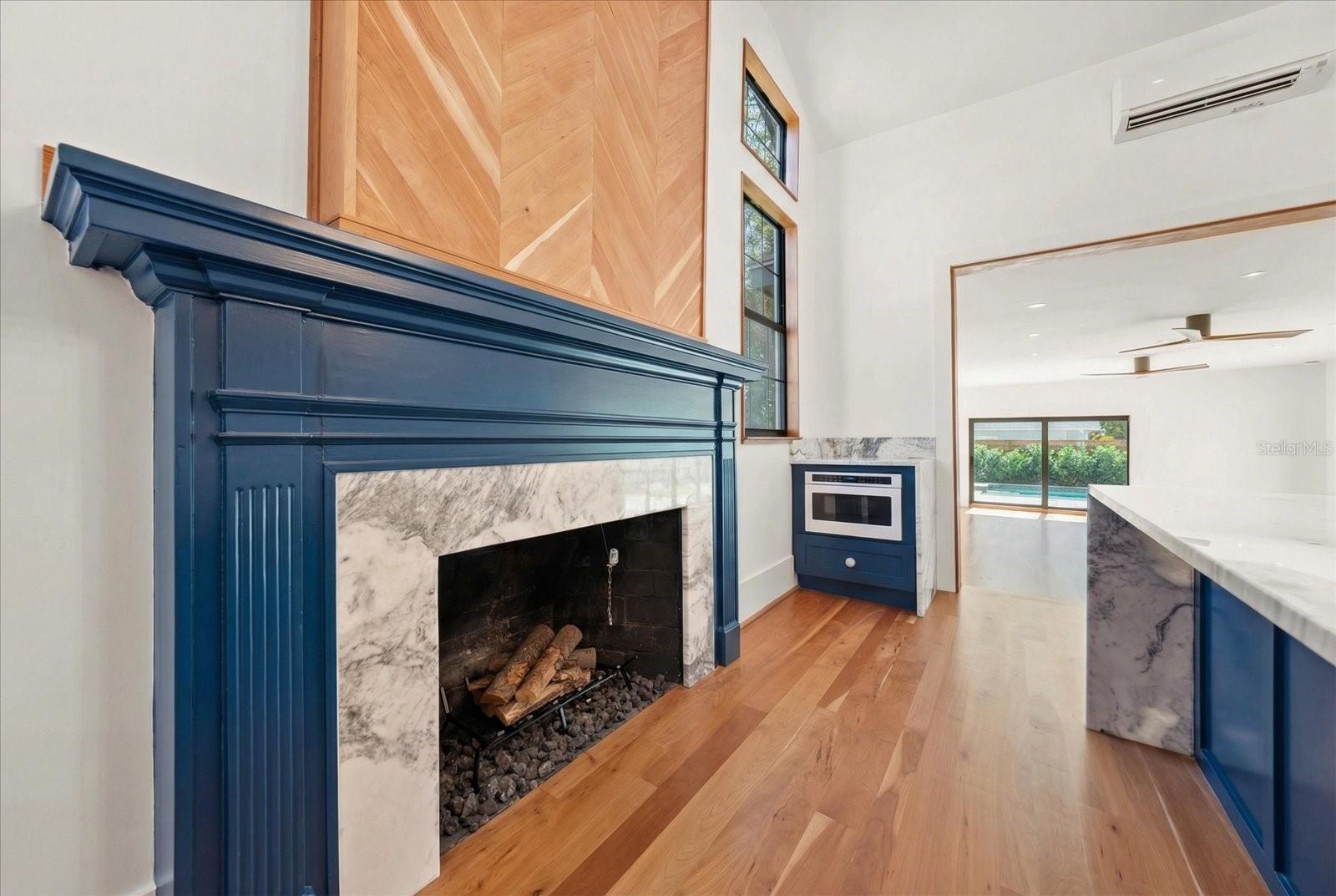 Kitchen fireplace and mantle original to the home. GE Café built in microwave drawer