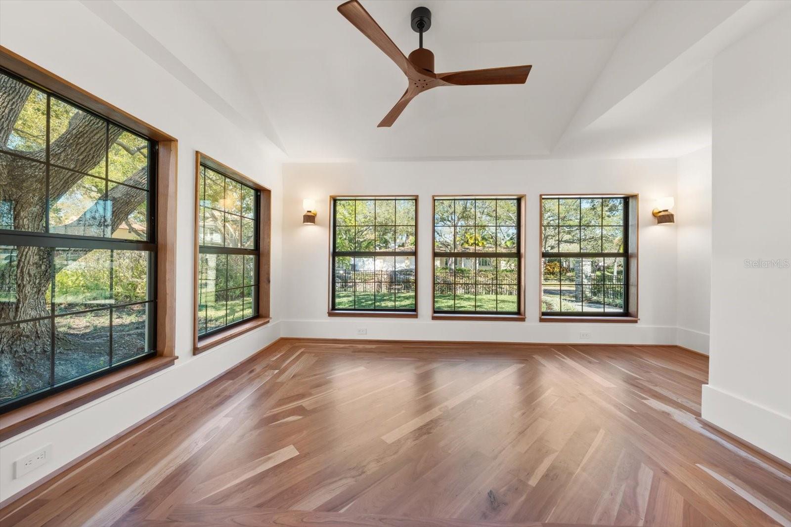 Primary bedroom and sitting room/study with wall sconces, cove ceiling