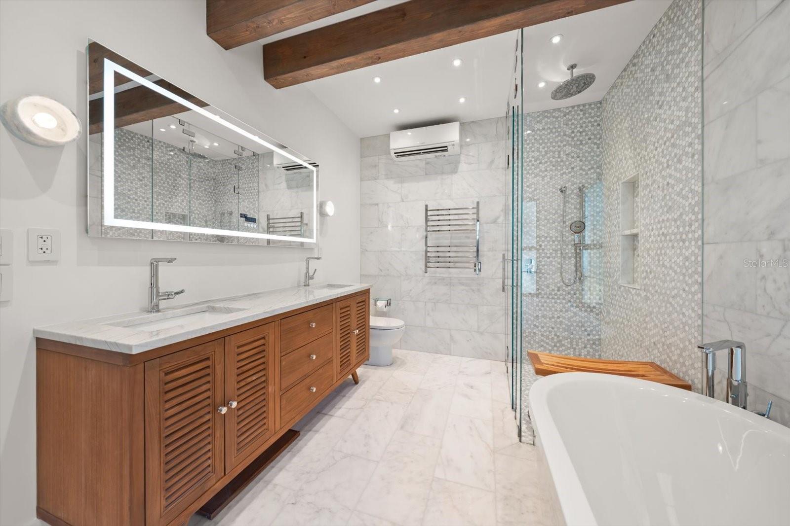 Primary en suite bath, Duravit soaking tub, zero entry glass shower, LED mirror, towel warmer