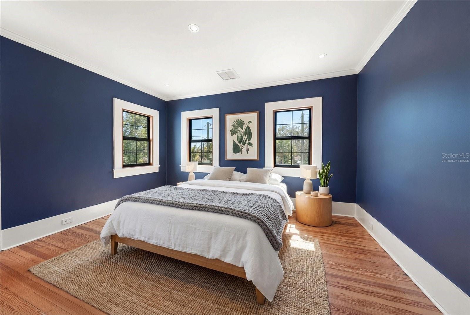 Bedroom #2 with windows overlooking pool and backyard, walk in closet with built in features. Virtually staged