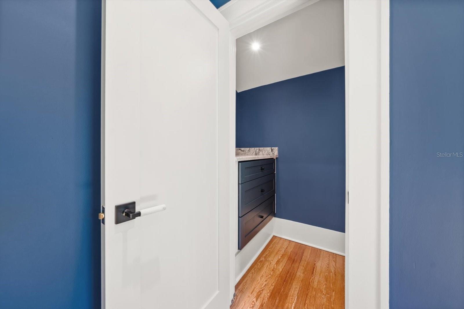 Bedroom #2 walk in closet with custom built in solid wood drawers and marble countertop