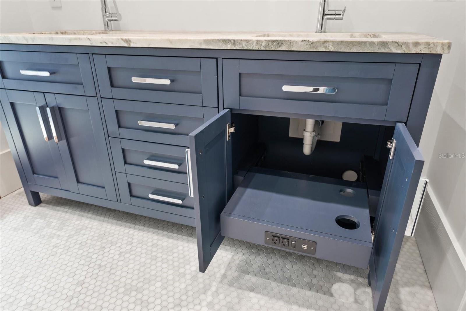 Hall bath with solid wood cabinetry featuring organizational compartments built in the drawers, roll out drawer with electric and phone charging, leathered granite countertop, dual sinks