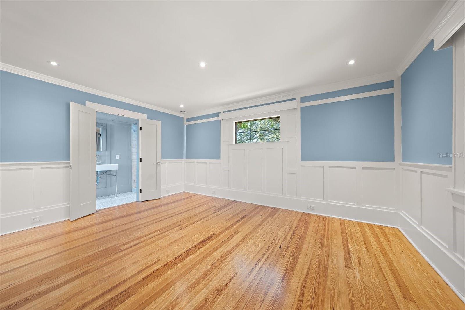 Bedroom #3 with en suite bath, shaker wall panels, custom wood window valances, walk in closet.  Double door entry to en suite bath