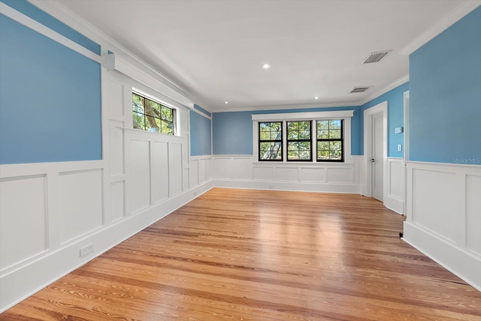 Bedroom #3 with en suite bath, shaker wall panels, custom wood window valances, walk in closet.