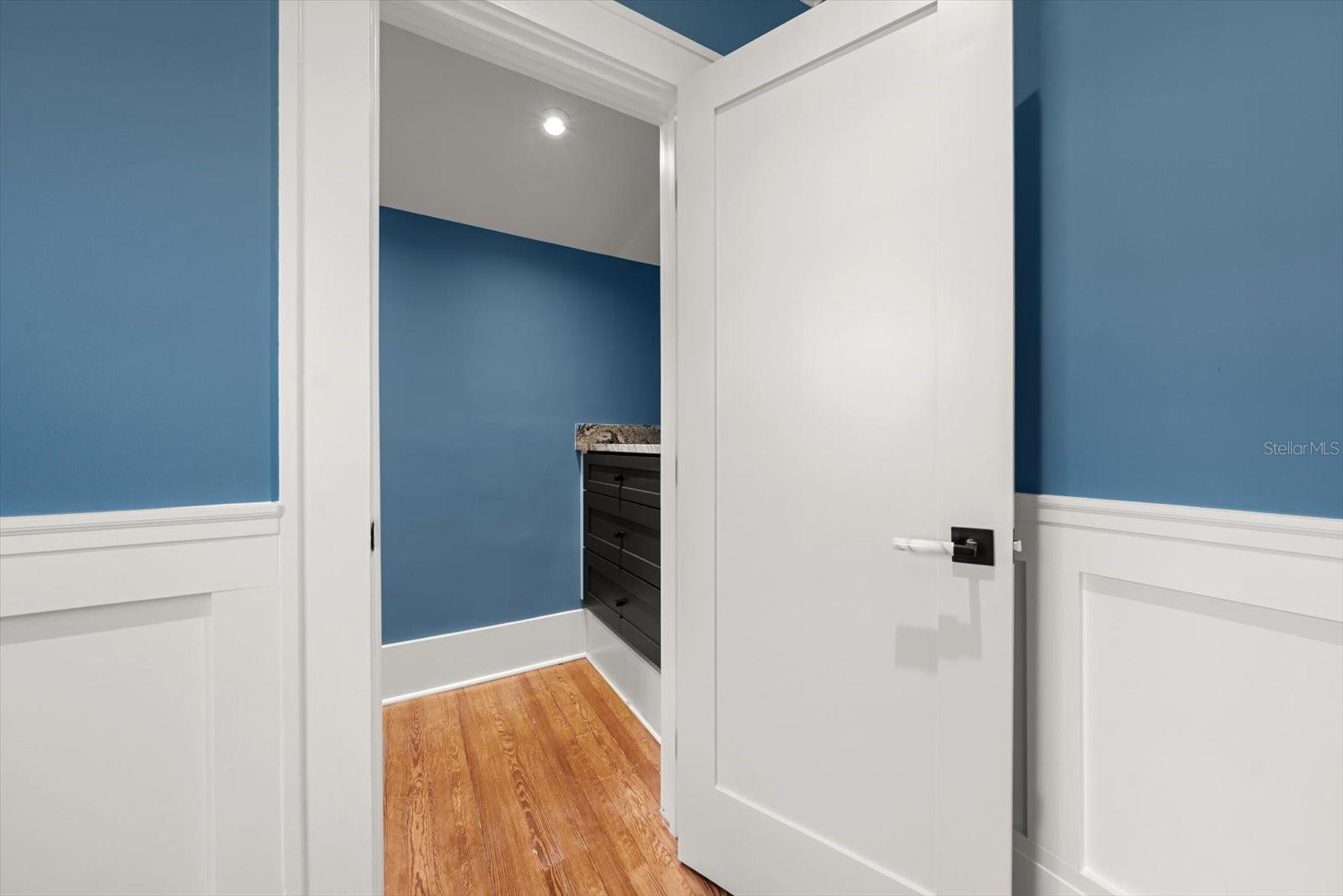 Bedroom #4 with walk in closet with custom built in drawers with marble countertop.
