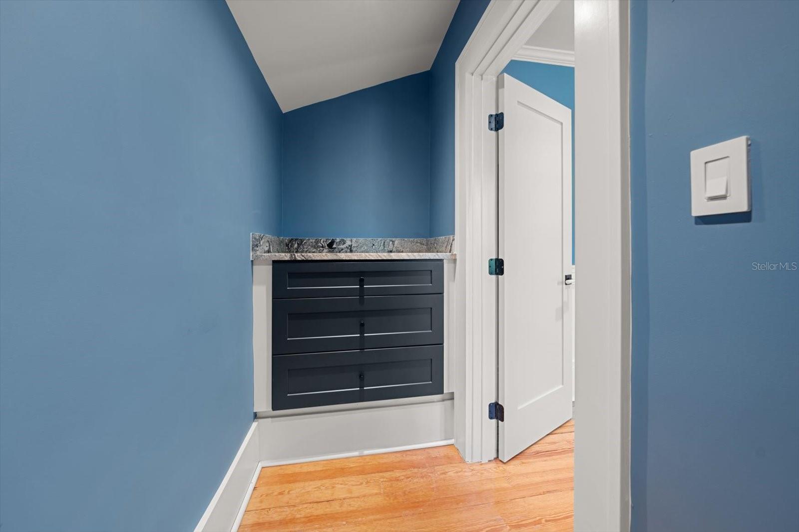 Bedroom #4 with walk in closet with custom built in drawers with marble countertop.