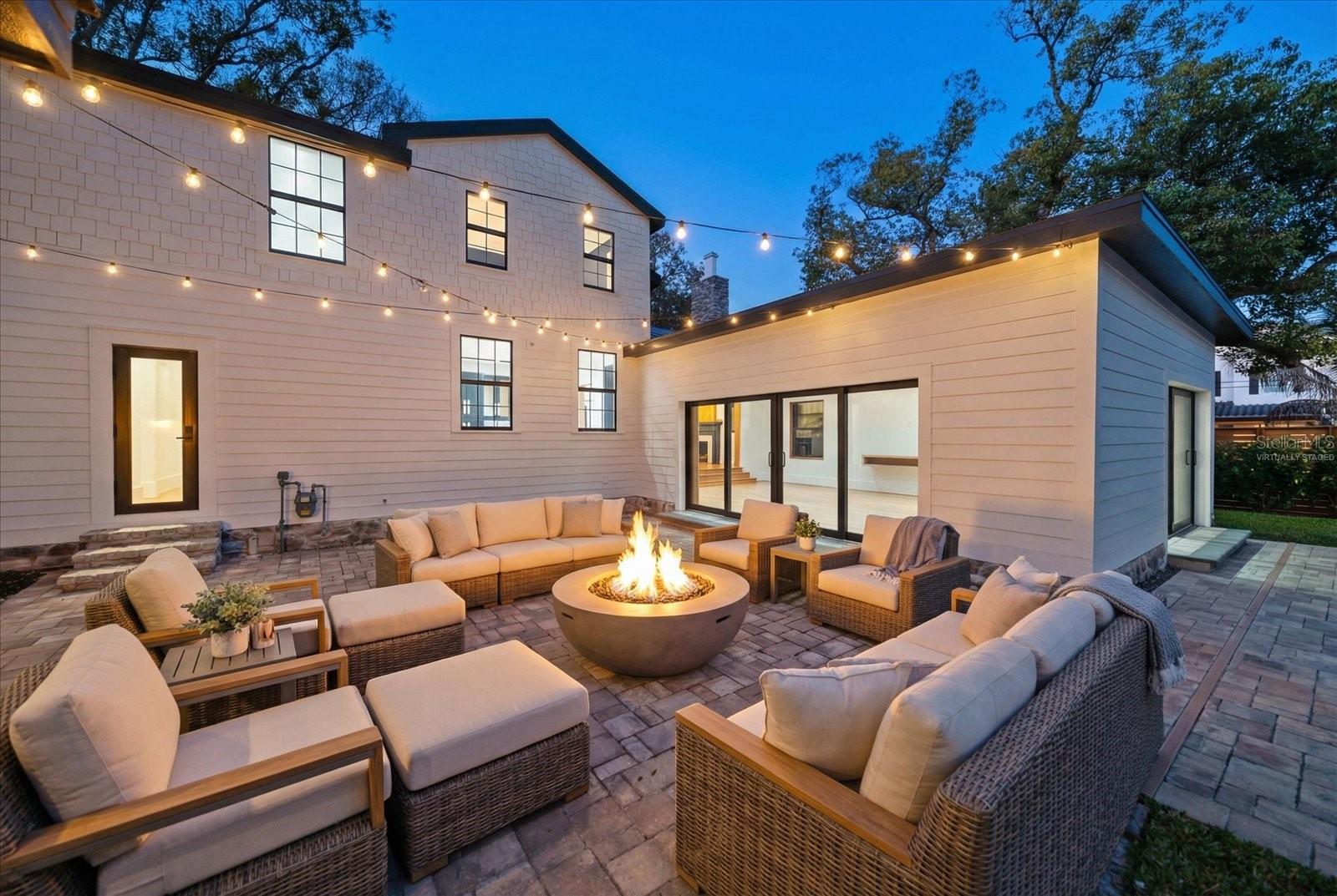 Expansive brick paver backyard living/entertaining space.  Virtually staged