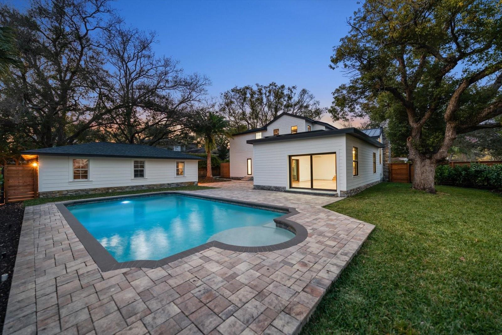 Expansive brick paver backyard living/entertaining space. Surrounded by lush landscaping, lots of grass and beautiful 7' deep pool with sunshelf and lighting.  Oversized 2 car garage with alley access.