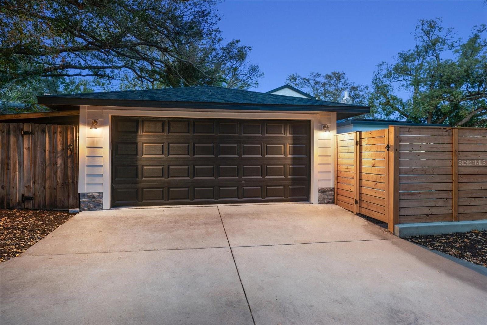 Alley access to oversized 2 car garage with hurricane rated garage door, garage door opener.  Extra parking space beside the fence in alley.  Storage shed for bikes and equipment.