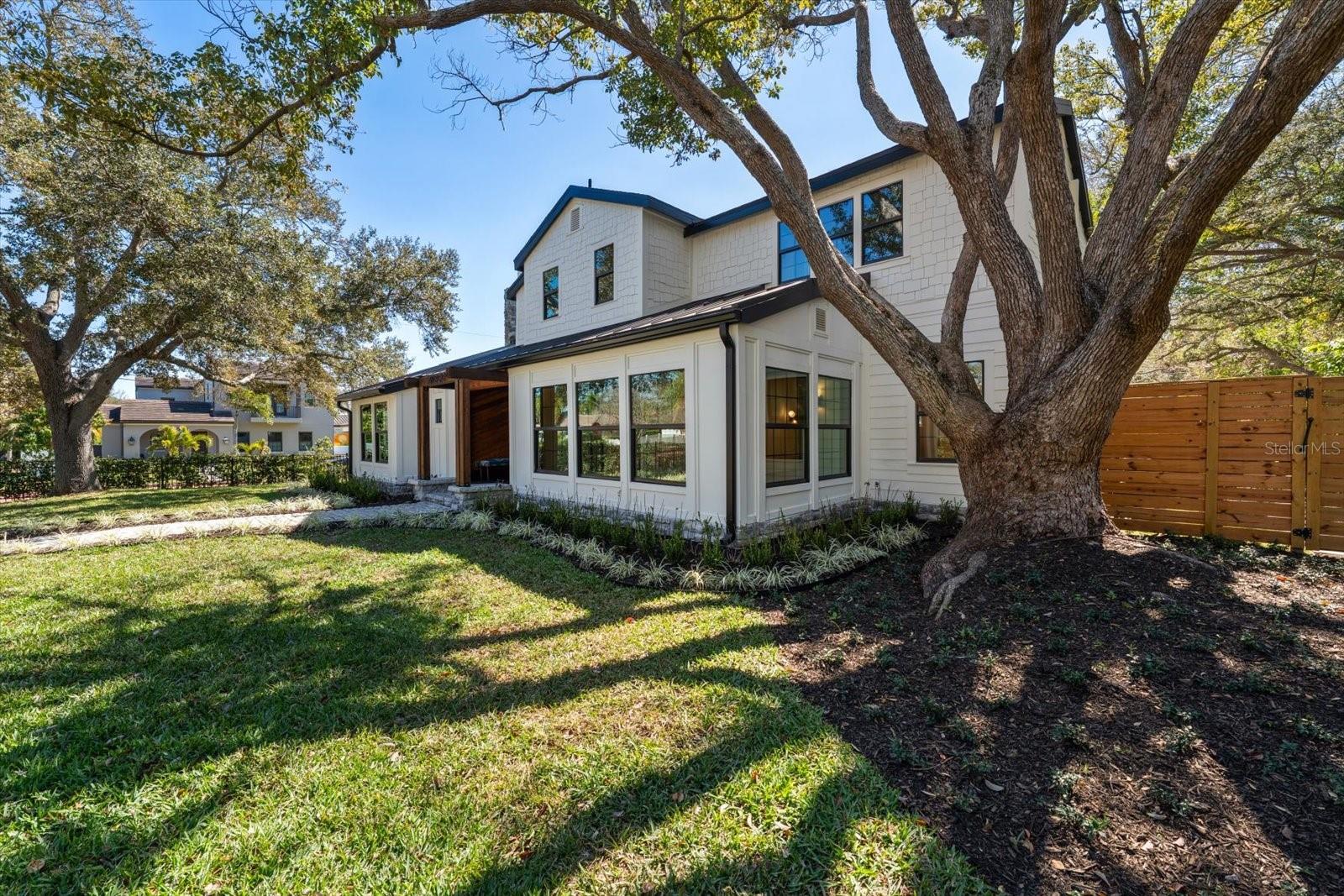 Northwest corner at front of home, grand shade tree, lush landscaping