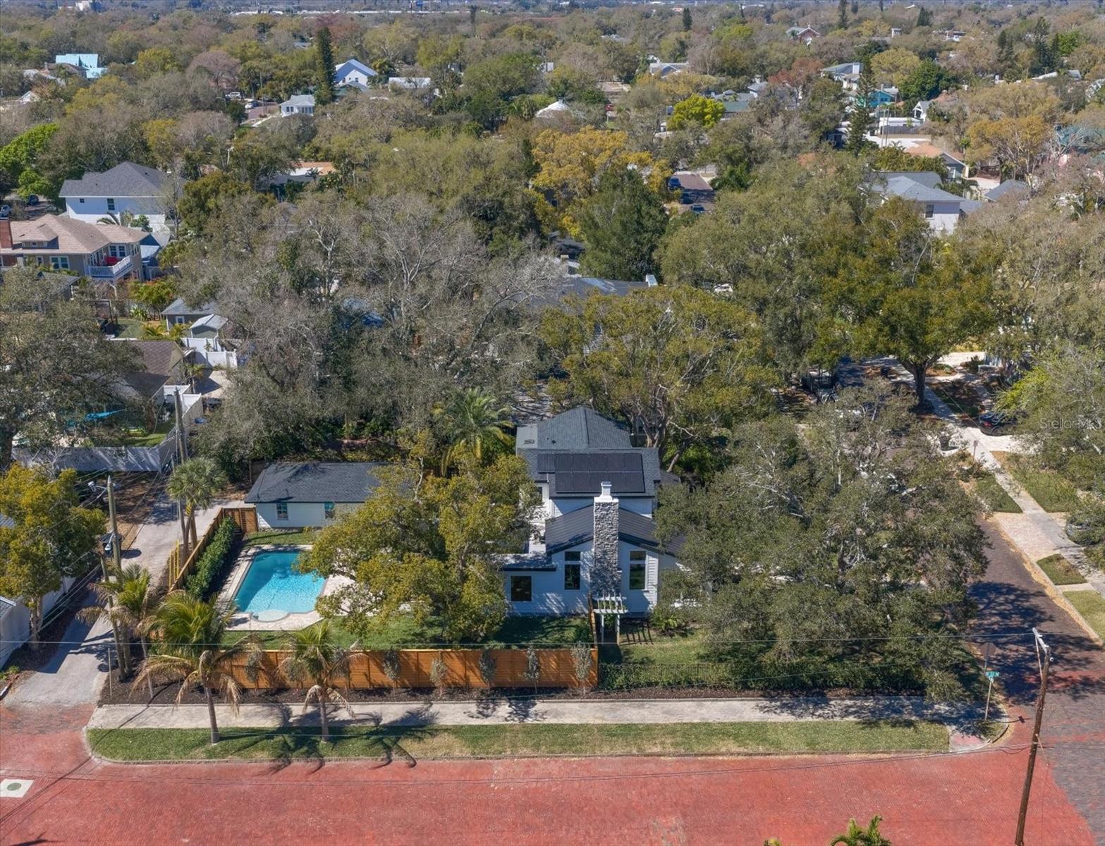 Aerial view from the east showing east side of property, corner lot, brick streets, alley access