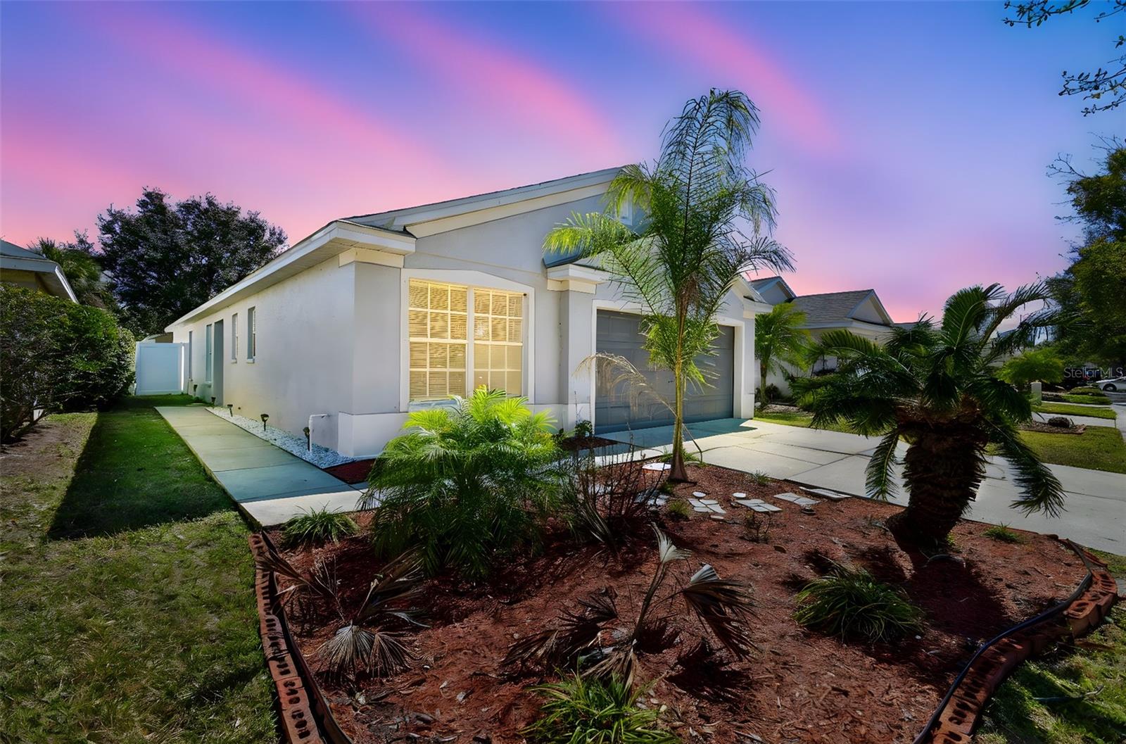 Palm trees, clean lines, and sunshine! This home makes a beautiful first impression.