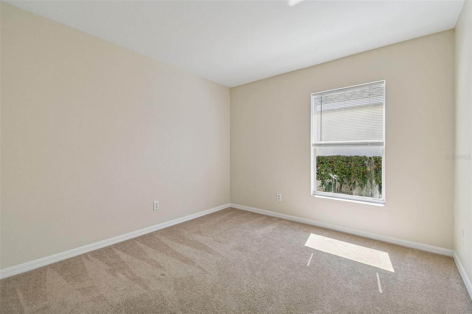 A light filled secondary bedroom that’s perfect for guests, a home office, or a growing household.