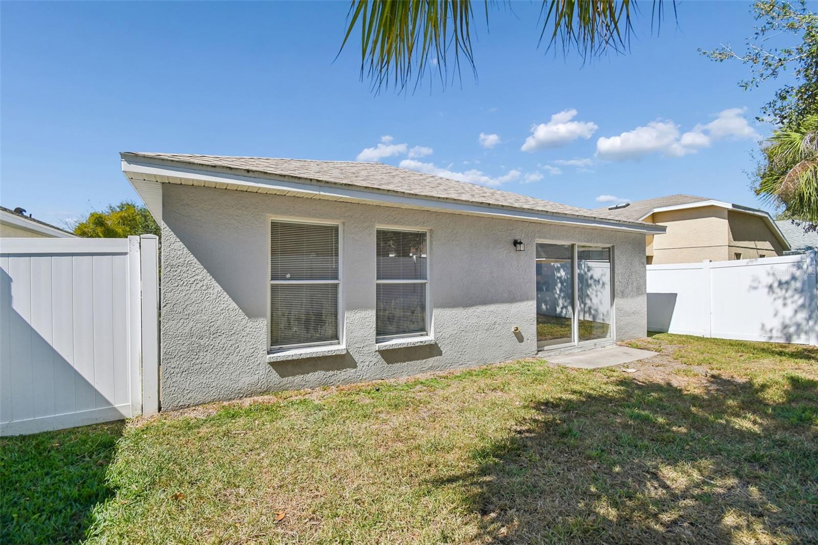 Spacious fenced yard with endless potential for a patio, fire pit, or future outdoor oasis.