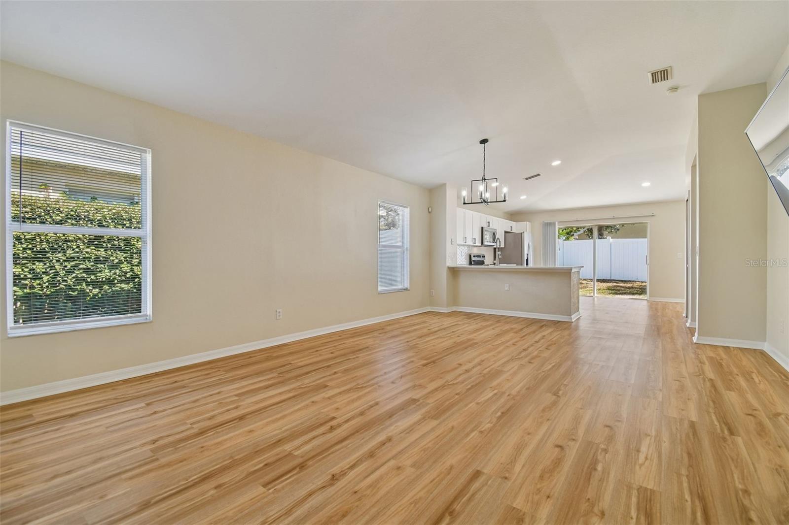 This is the kind of open layout everyone is looking for — light filled, spacious, and perfectly connected to the kitchen and backyard for easy Florida living.