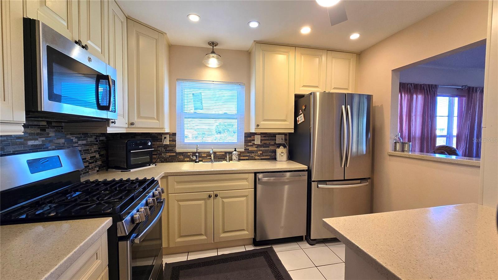 Beautifully updated kitchen with recess lighting throughout, gas range (HOA pays the gas bill-included in the monthly HOA fee), newer dishwasher, Corian countertops.
